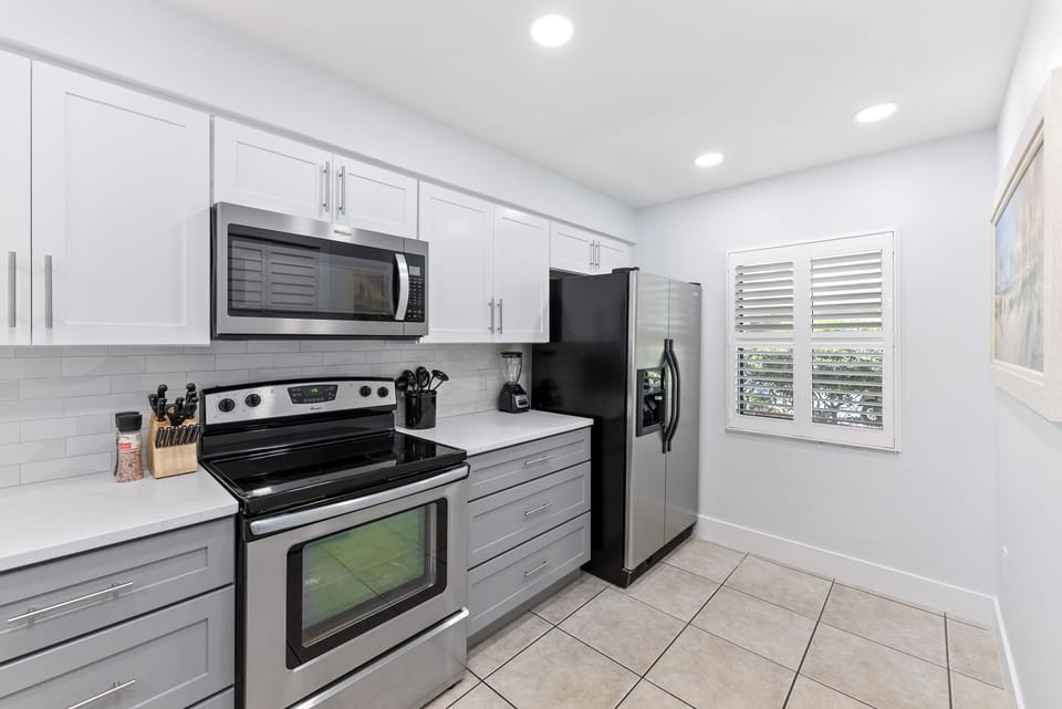 A fully equipped kitchen with stainless appliances and a spacious cooking area
