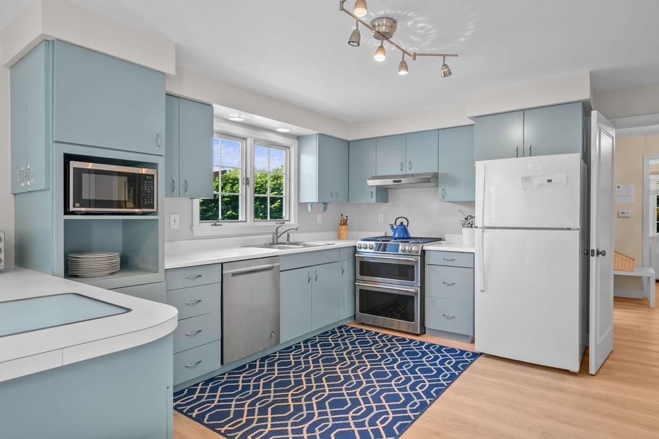 Washing the dishes (or loading them in the dishwasher) doesn't seem so much of a chore when overlooking the private yard space below - 13 Monomoy Circle Chatham Cape Cod - BreakAway - NEVR
