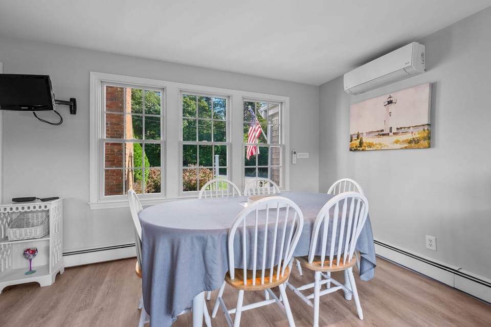 Dining table with seating for six and a nearby slimline AC - 13 Monomoy Circle Chatham Cape Cod - BreakAway - NEVR