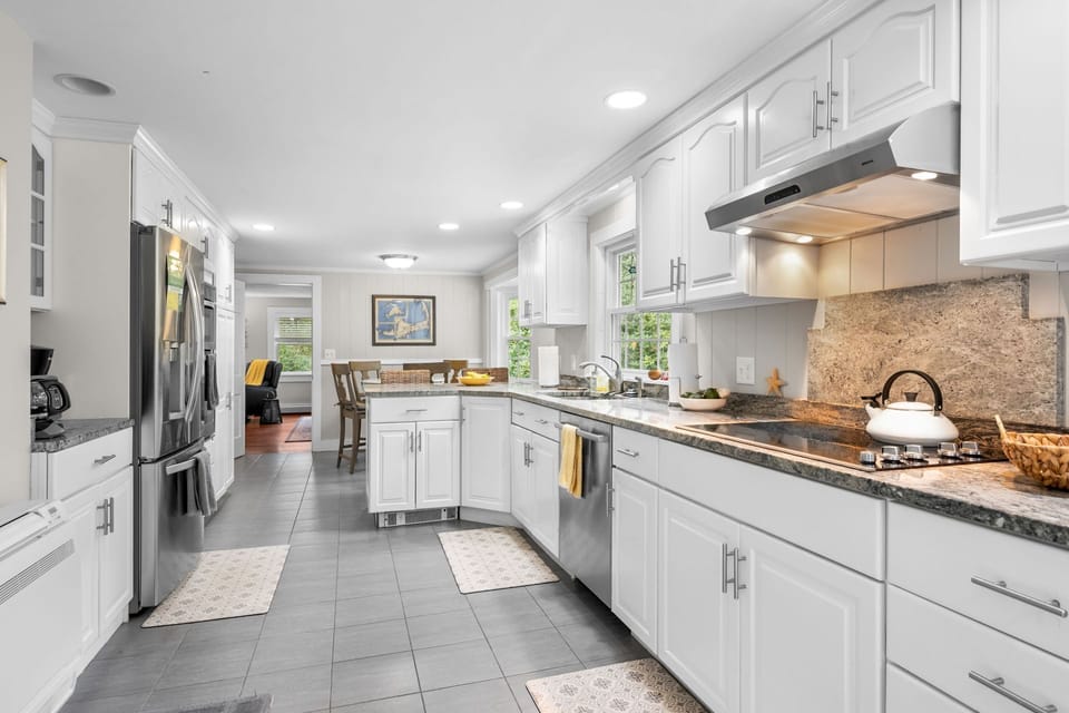 Entering the kitchen of the home, you are greeted with stainless steel appliances and plenty of counter space - 4 Long Pond Drive Harwich Cape Cod - Cape Retreat - NEVR