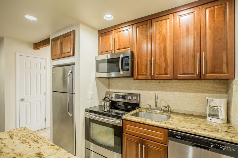 Your fully equipped kitchen features rich wood cabinets, granite countertops, and stainless steel appliances for all your culinary adventures.