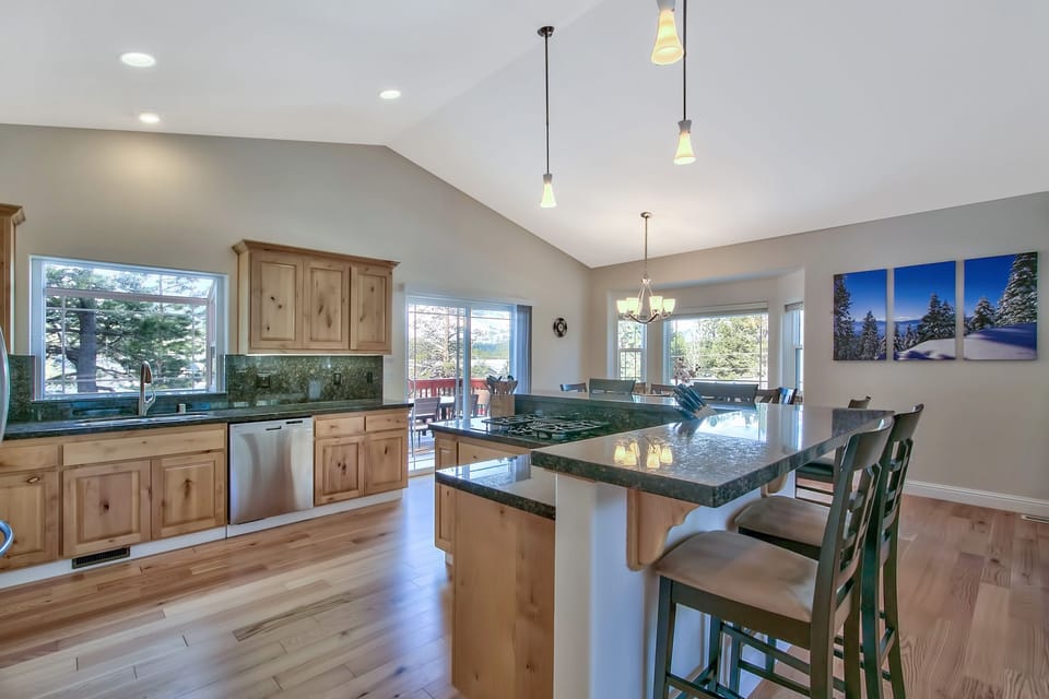 Your spacious kitchen features granite countertops, warm wood cabinetry, and a breakfast bar where you can enjoy morning coffee with garden views.