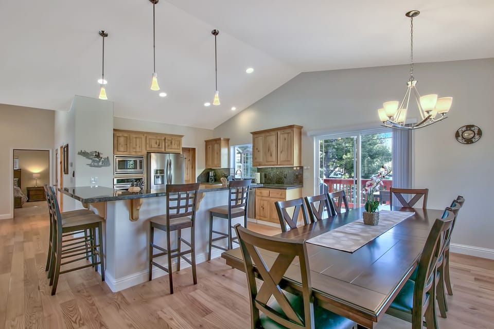 Your open-concept kitchen and dining space flows seamlessly together, featuring warm wood cabinetry, granite counters, and seating for memorable meals with family.