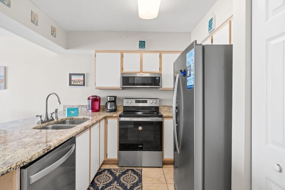 Kitchen - Make your favorite meals in this well stocked kitchen.  The countertops are granite & there is lots of cabinet space.