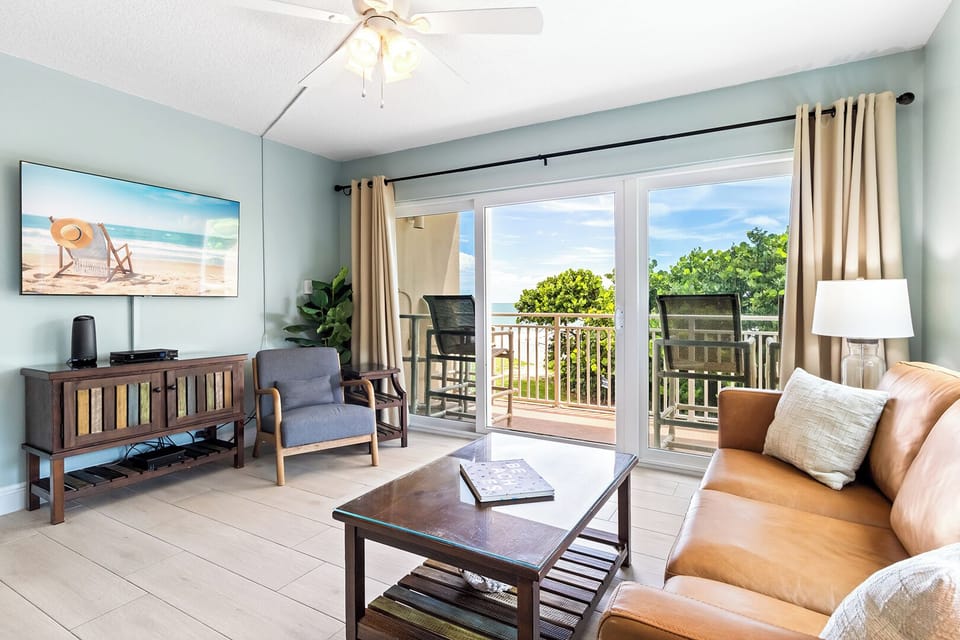 Bight & airy living room leads to outdoor balcony