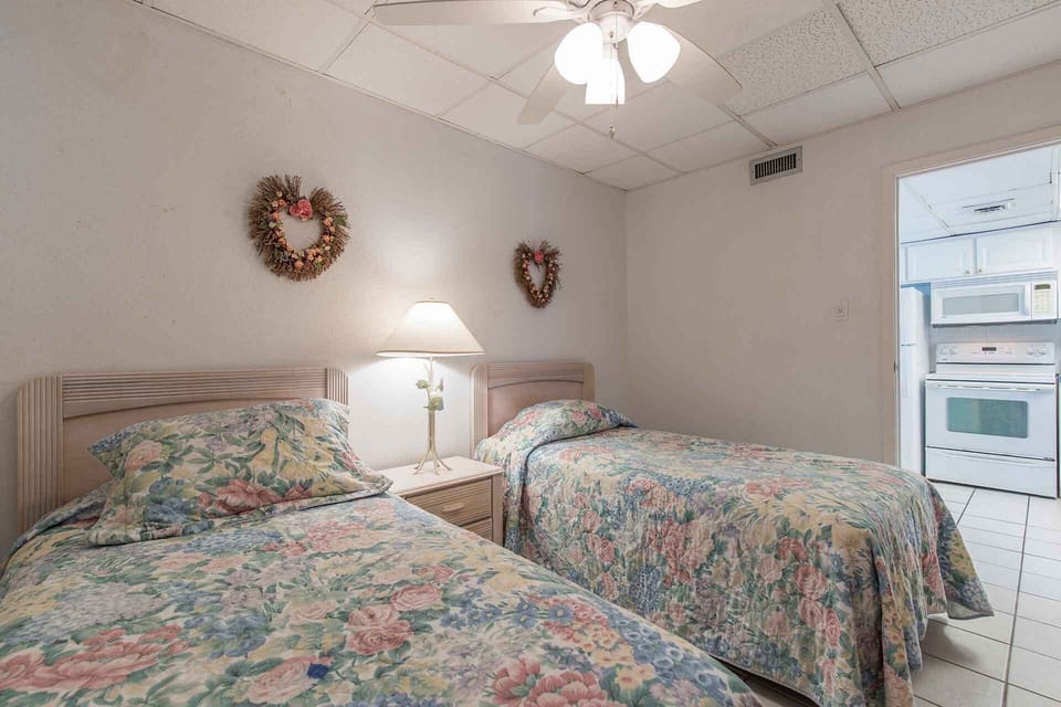 The second bedroom has two twin-size beds and is right off from the kitchen