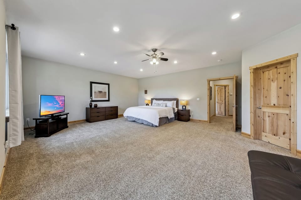 Unwind in your spacious master bedroom with plush carpeting, cozy seating, and entertainment at your fingertips.