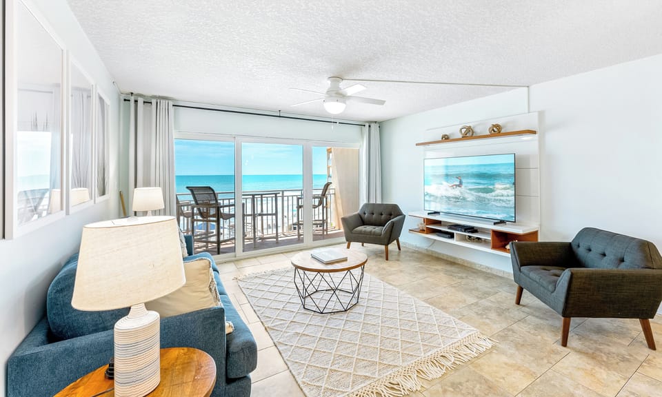 Cozy and inviting seating area with direct access to a private balcony overlooking the ocean.