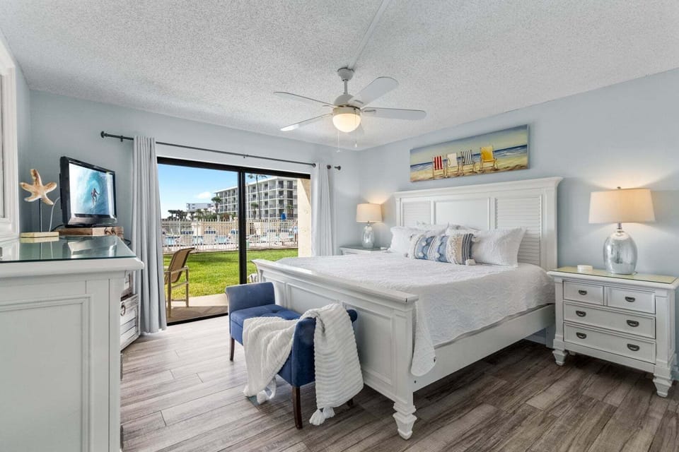 Master bedroom- Plush king bed, TV, and leads to walk out patio