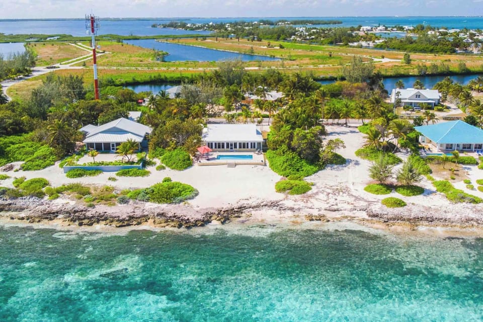 Aerial view of the home with the Cayman Kai neighborhood in the background.