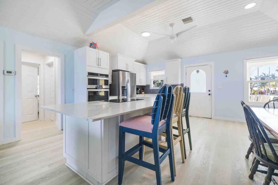 Renovated kitchen with breakfast bar seating.