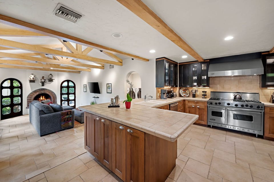 Cook your favorite meals in this spacious kitchen with professional-grade appliances and ample prep space, while warming up by the cozy fireplace in the connected living area.
