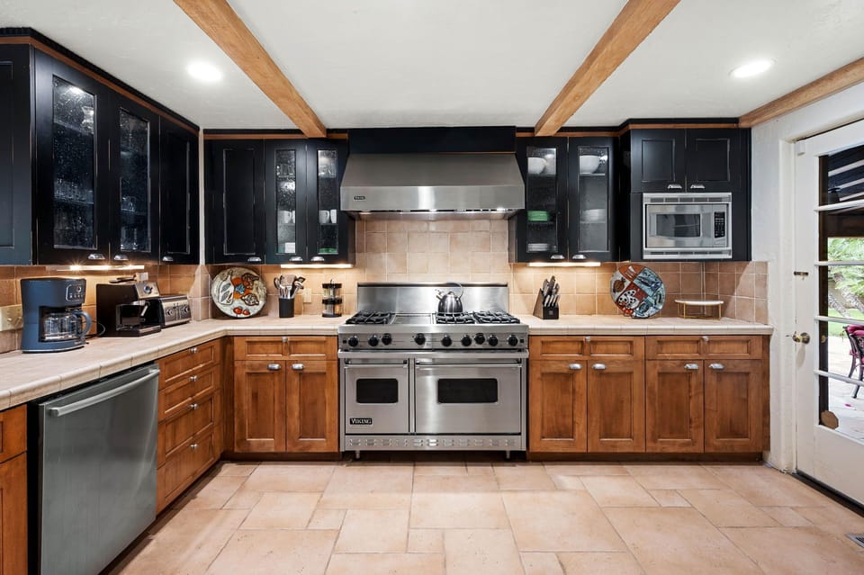 Picture yourself preparing meals in this spacious chef's kitchen, complete with professional-grade appliances and warm wood cabinetry—a perfect blend of style and function for your culinary adventures.
