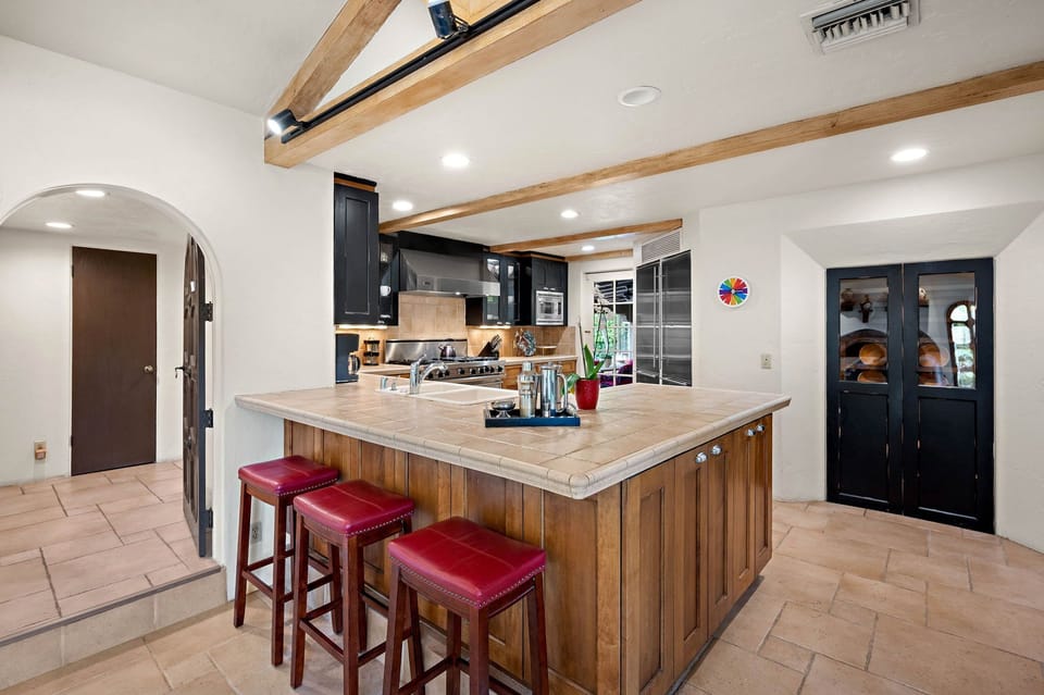 Gather around the spacious island in your fully-equipped kitchen, where rustic beams and modern appliances blend beautifully—perfect for preparing meals and making memories together.