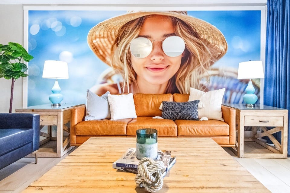 Unwind in this comfy living space with vibrant decor and a direct view of the patio and ocean dunes.