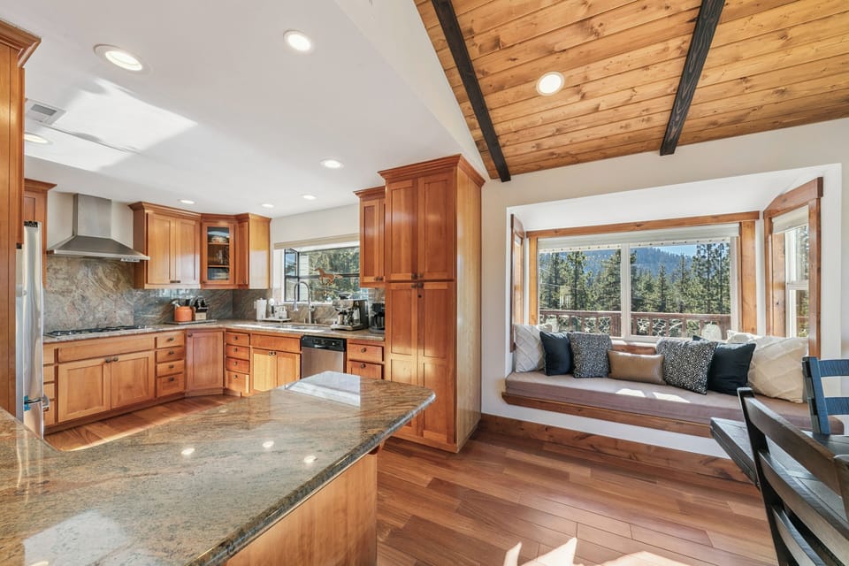 Gather in your beautiful kitchen with warm wood cabinets and granite counters, then relax in the cozy window nook with stunning mountain views.
