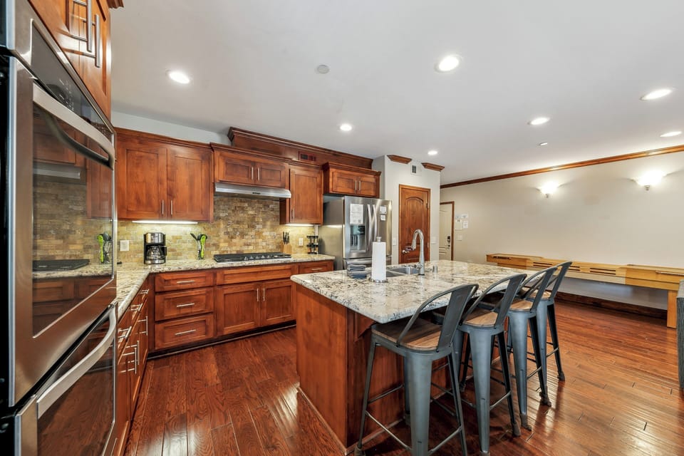 Your spacious gourmet kitchen features rich cherry cabinets, granite countertops, and modern appliances for effortless meal preparation.