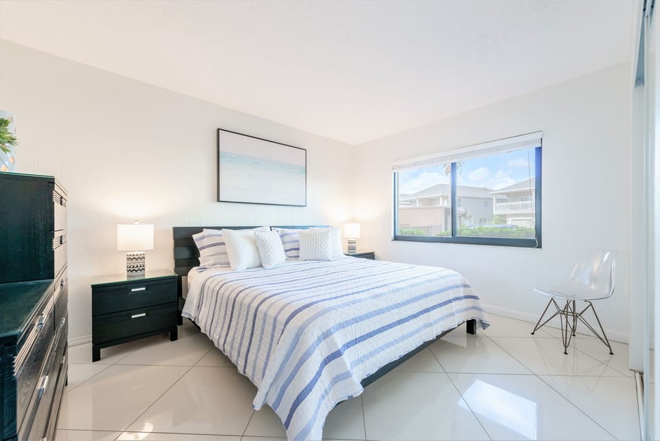 Guest bedroom retreat with a plush king bed and plenty of natural light.