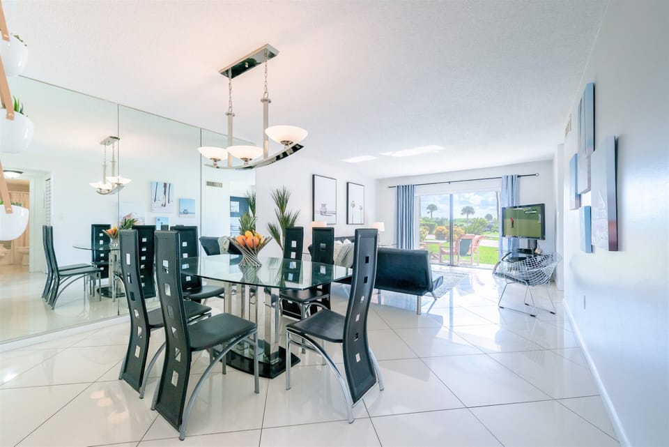 Elegant dining area seats six with sleek furnishings and natural light.