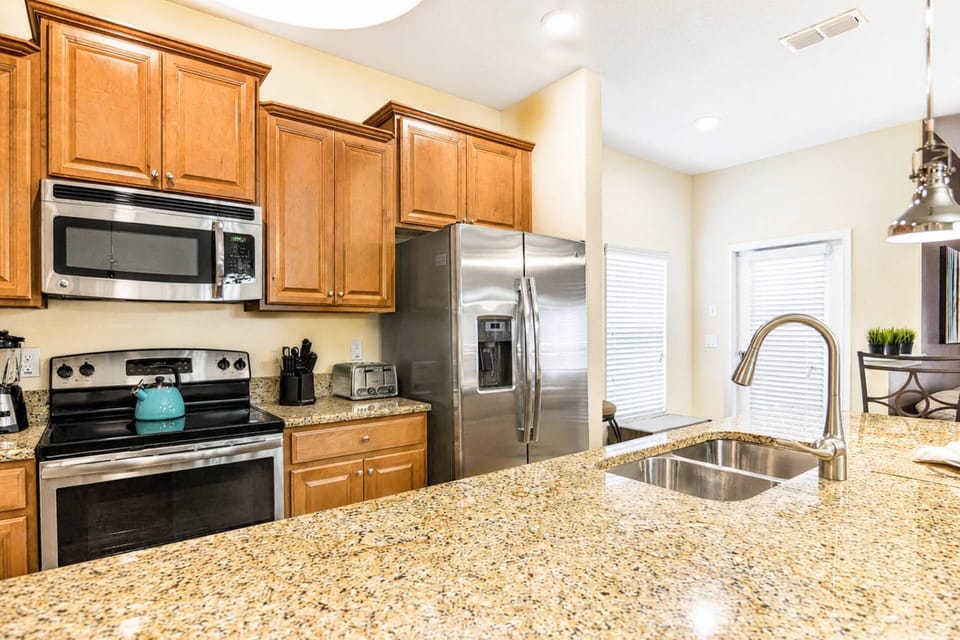 Fully equipped kitchen with granite counters and stainless steel appliances