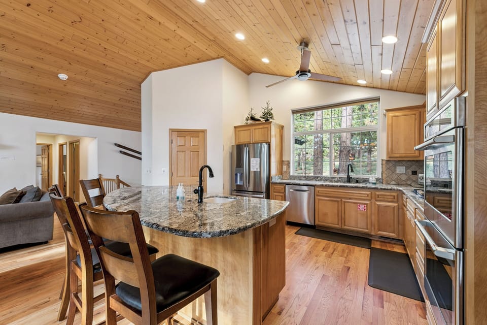 Your spacious kitchen features granite countertops and mountain views, perfect for preparing meals while staying connected with loved ones.