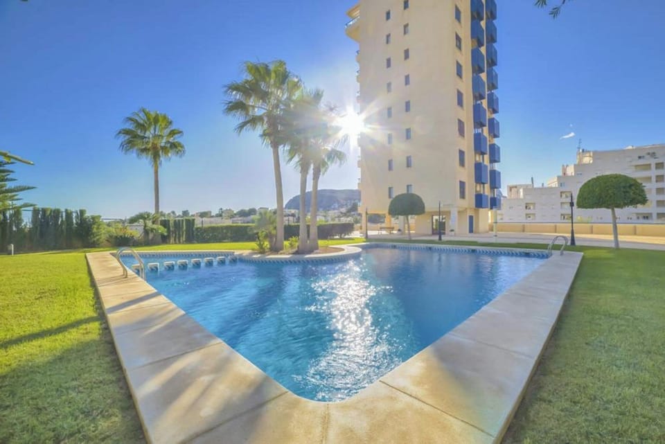 We are pleased to present you our beautiful holiday apartment with communal pool in Calpe, Costa Blanca. This apartment sleeps 4 people and has two bedrooms and two bathrooms.Inside the apartment, you will find a spacious living-dining room with TDT/SAT TV, air conditioning and access to the terrace. The kitchen is independent and fully equipped with a ceramic hob and dishwasher. The two bedrooms have a double bed each and also have air conditioning. One of the bedrooms has an en-suite bathroom with a bathtub. In addition, there is another bathroom with a shower.Outside, the apartment offers a pleasant area with a communal pool, Roman steps and outdoor shower, perfect for cooling off on hot summer days. There is also a tennis court available to guests, as well as a parking space for one vehicle.The location of the apartment is privileged, since it is close to the sea and all services. The nearest rock cove is just 750 meters away, and the restaurants and center of Calpe are 900 meters away. Furthermore, the nearest supermarket is just 350 meters from the apartment.Importantly, we offer free WiFi so you can stay connected during your stay. In addition, pets up to 12 kg are allowed with an additional fee.We hope you enjoy your stay in our beautiful holiday apartment with communal pool in Calpe. If you have any additional questions or need more information, do not hesitate to contact us.