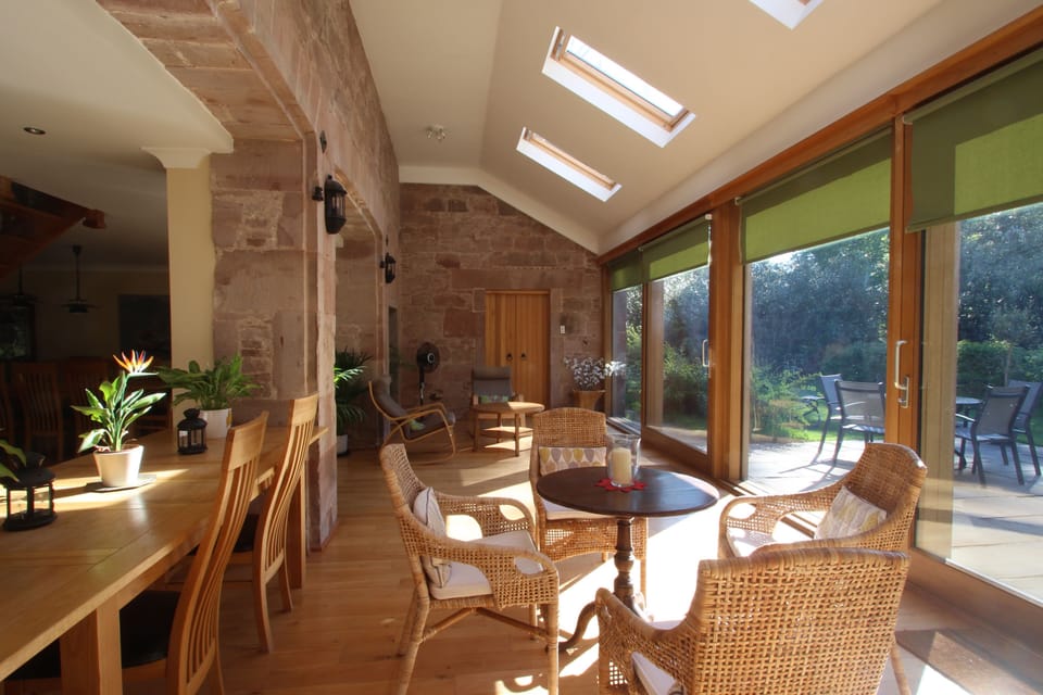large bright sun room area that opens out onto the terrace