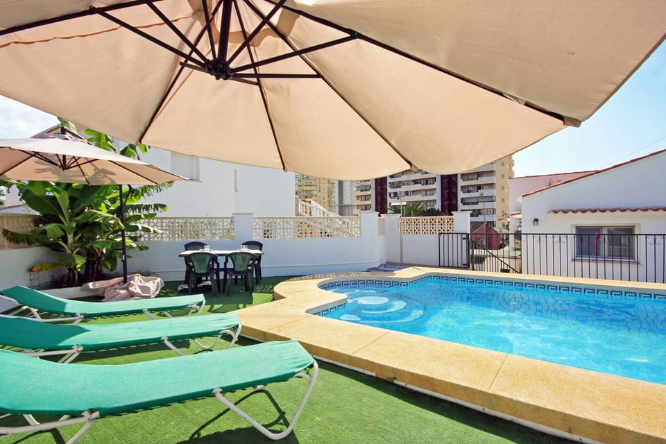 Pleasant summer villa with private pool in Calpe (Costa Blanca) for 12 people, with six bedrooms and four bathrooms, spread over two floors. It has air conditioning in the living room and in all bedrooms.INTERNAL: This villa consists of the GROUND FLOOR, which consists of a living-dining room with TV SAT/TDT, air conditioning, an American bar and access to the terrace and the pool. A fully equipped separate kitchen with dishwasher and ceramic hob. Two bedrooms each with a double bed. There is also a bathroom with a shower. The UPPER FLOOR consists of three bedrooms, each with two single beds, two of them with a bathroom with shower en suite. A double bedroom and finally a washroom.EXTERNAL: A large 10x5 pool fenced for child safety with roman steps and outside shower. There is also a built in barbecue and parking for 4 vehicles on the same property.LOCATION: Without a doubt, an unbeatable location, just 250 m from the nearest supermarket and restaurants. The sandy beach with all services is only 650 m away. There is also a cove 400 m away and Calpe town center 3 km away.REMARKS: Free wifi. Pets up to 12 kg are allowed at an additional cost.