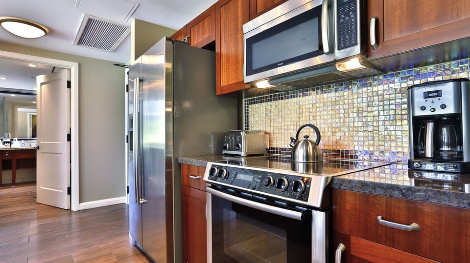 Stainless steel appliances create a clean modern feel in this condo. 