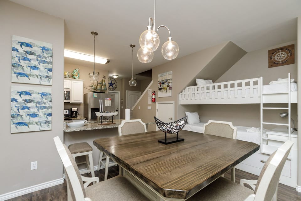 Your spacious dining area flows seamlessly into the kitchen, with charming nautical touches and bunk beds perfect for family gatherings.