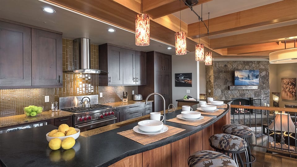 Your gourmet kitchen awaits with professional-grade appliances, sleek granite counters, and a stylish island where you'll gather for meals or morning coffee beneath elegant pendant lighting.