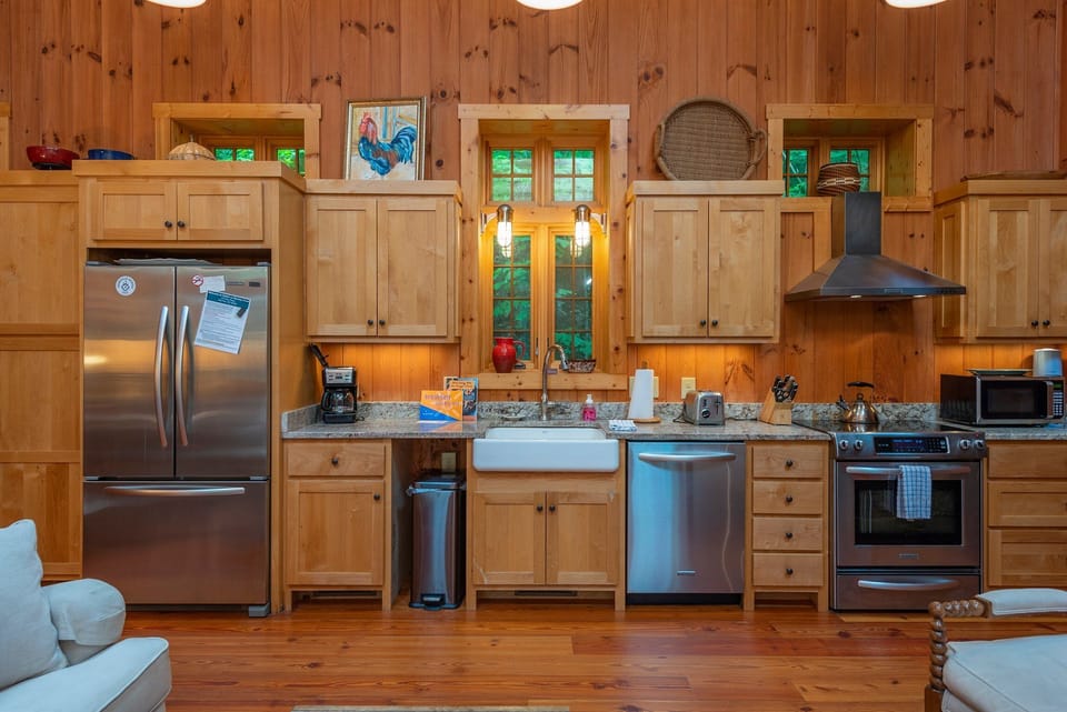 Kitchen with farmhouse-style sink, dishwasher, and drip-style coffeemaker.