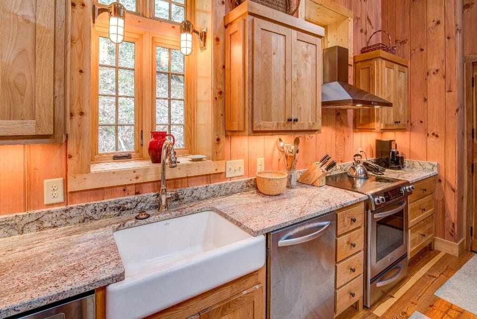 Kitchen with farmhouse-style sink, dishwasher, and drip-style coffeemaker.