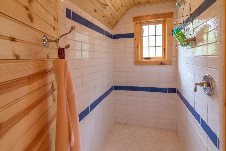 Upper-level en suite bath with walk-in shower (door opens to bedroom and is separate from the toilet and sink).