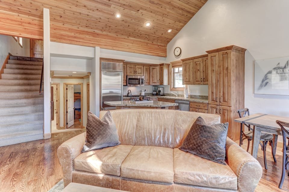 Living room with fireplace, 55" HD Smart TV, dining area and private deck