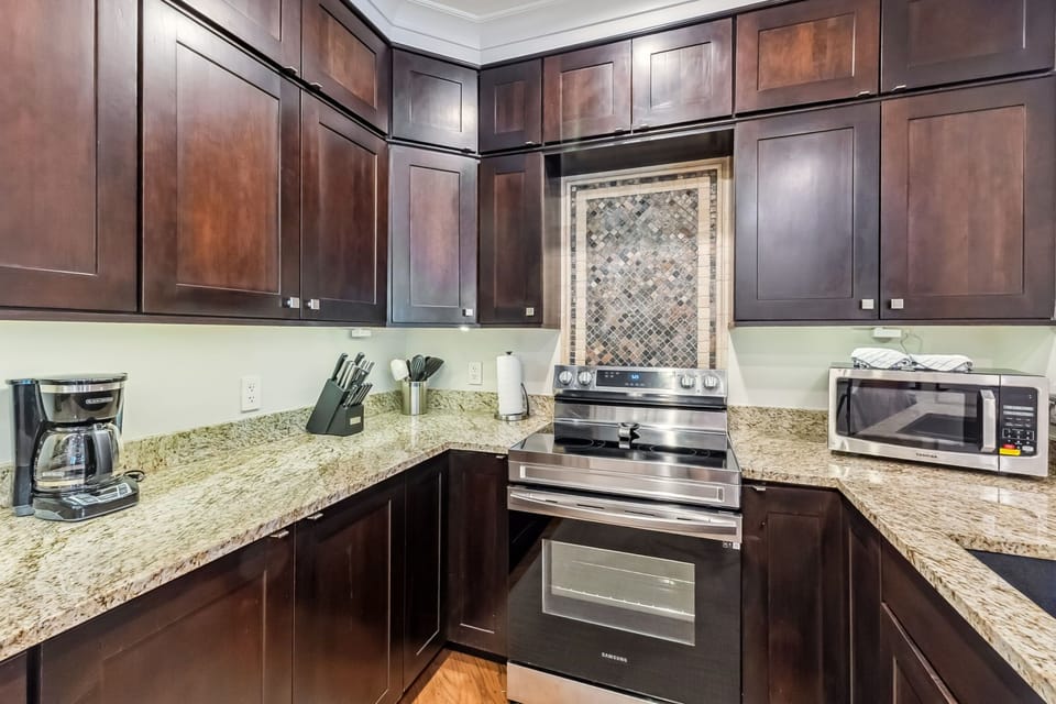 Your gourmet kitchen awaits with rich cherry cabinets, granite countertops, and premium stainless steel appliances for memorable meal preparation.