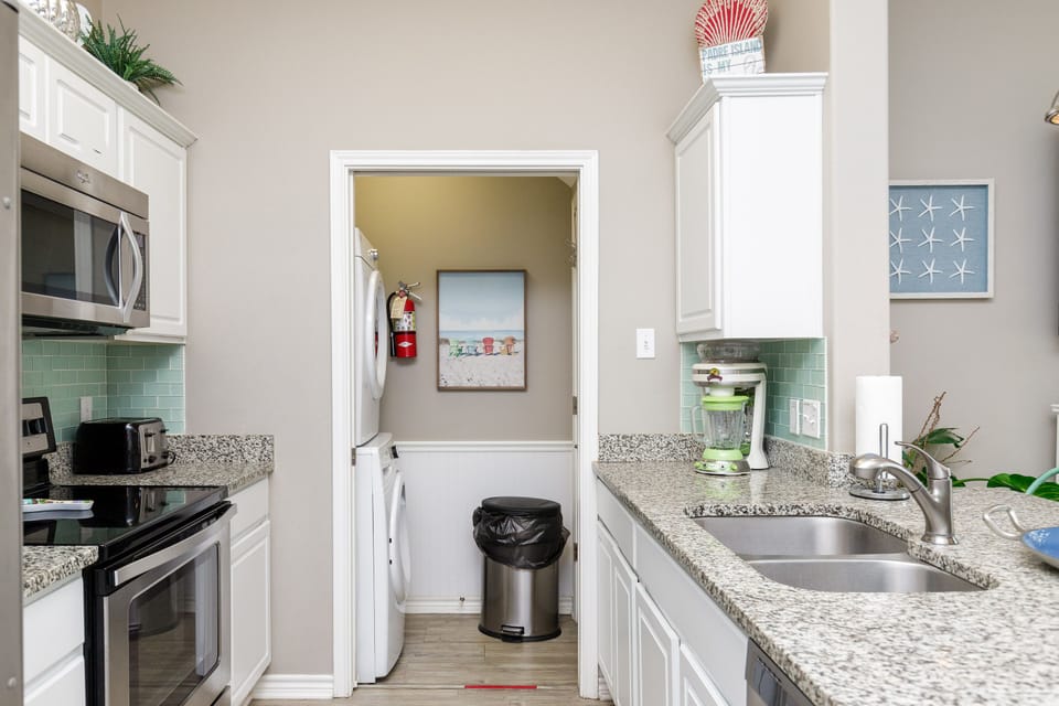 Your fully equipped kitchen features granite counters, stainless appliances, and connecting laundry room for ultimate convenience.