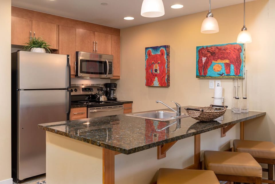The breakfast bar seats three and looks into the open kitchen