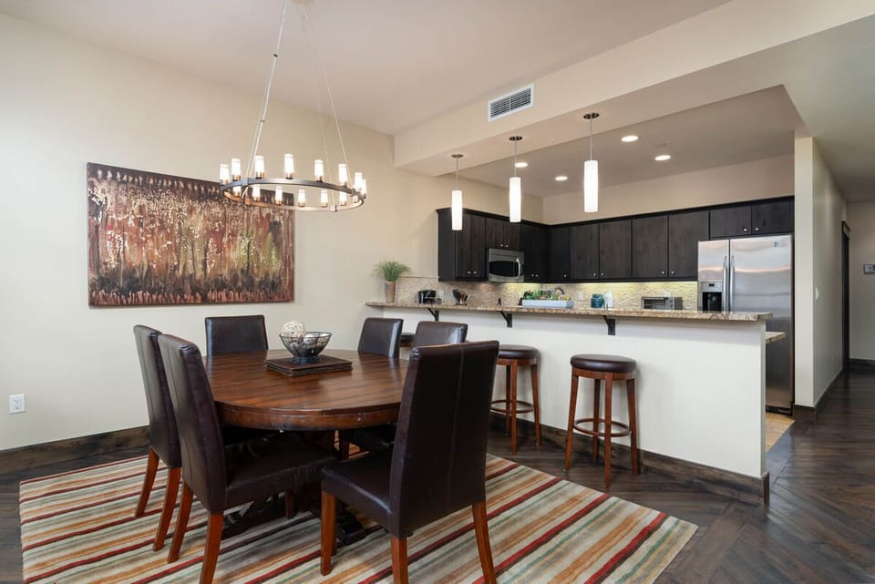 Dining table seats six, with additional bar side seating for five