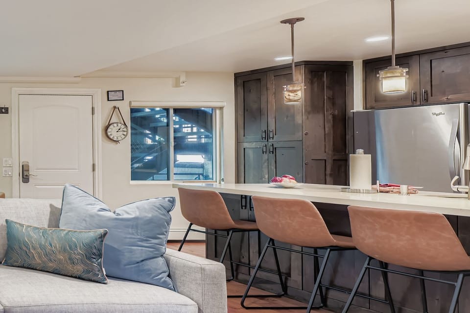 Your stylish open-concept space features a modern kitchen with stainless steel appliances and a comfortable seating area.