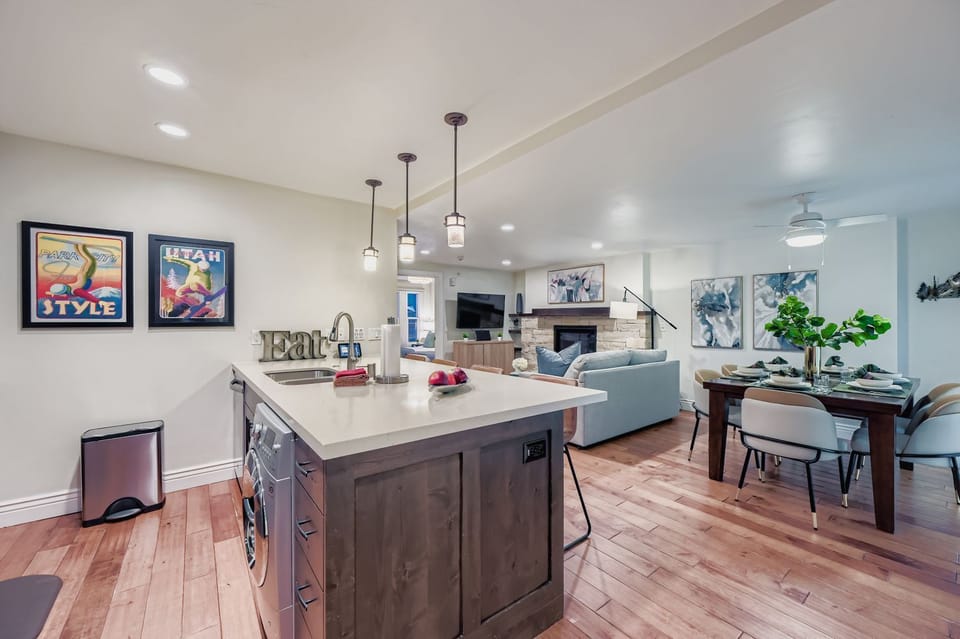 Spacious open-plan living featuring a modern kitchen island where you can prepare meals, comfortable seating area for relaxing.