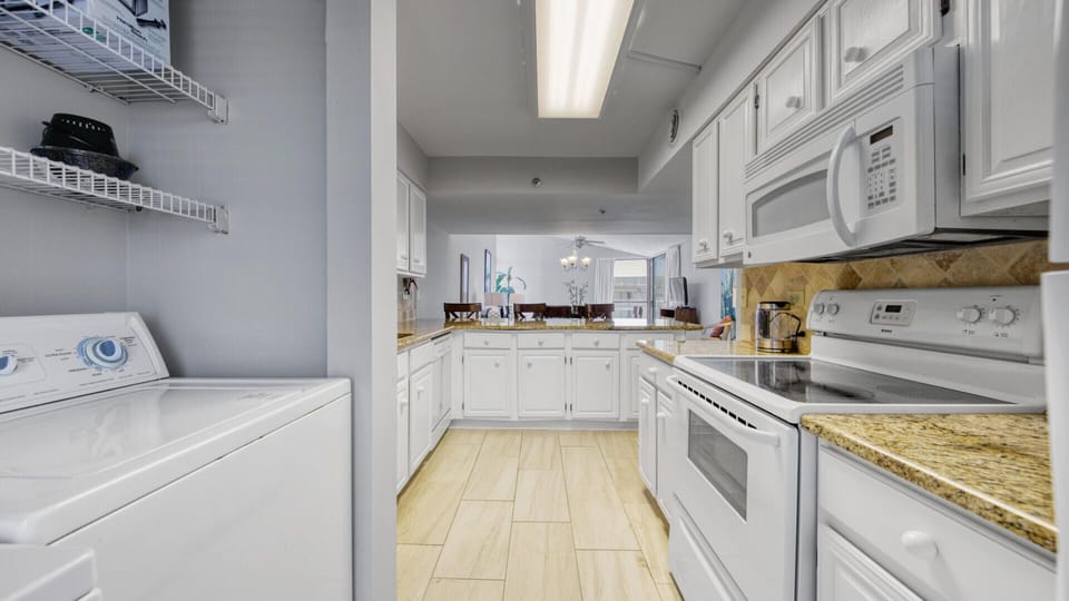 Well Equipped Kitchen With Washer and Dryer Tucked Away