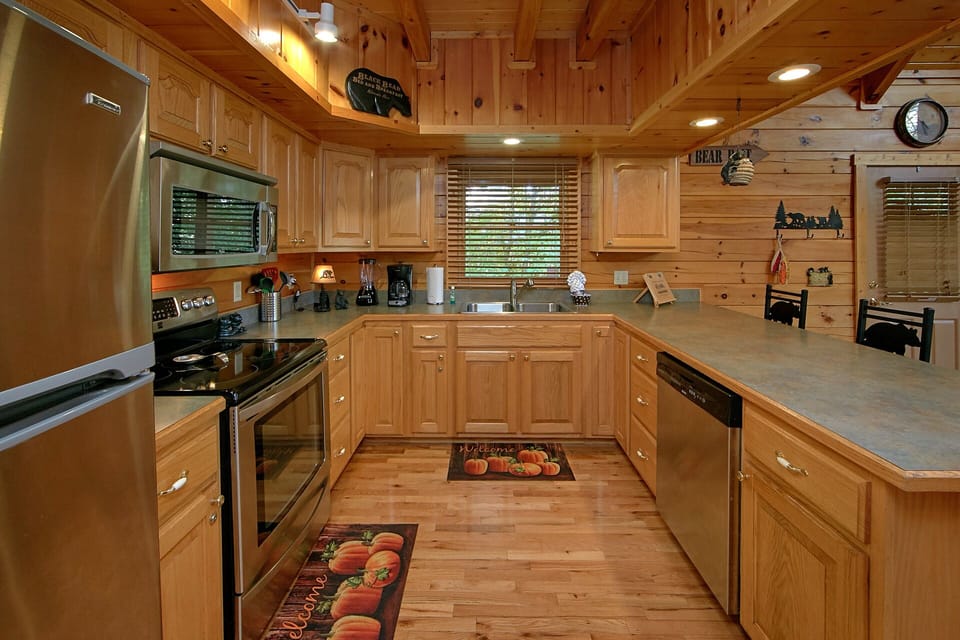 Large Kitchen - Stainless appliances, at-home kitchenware, and plenty of seating allow for fantastic dining at your cabin!