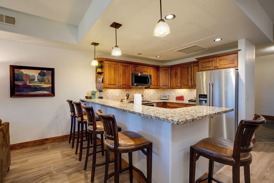 Your gourmet kitchen invites culinary adventures with granite countertops, premium appliances, and a breakfast bar perfect for morning coffee or evening conversations.