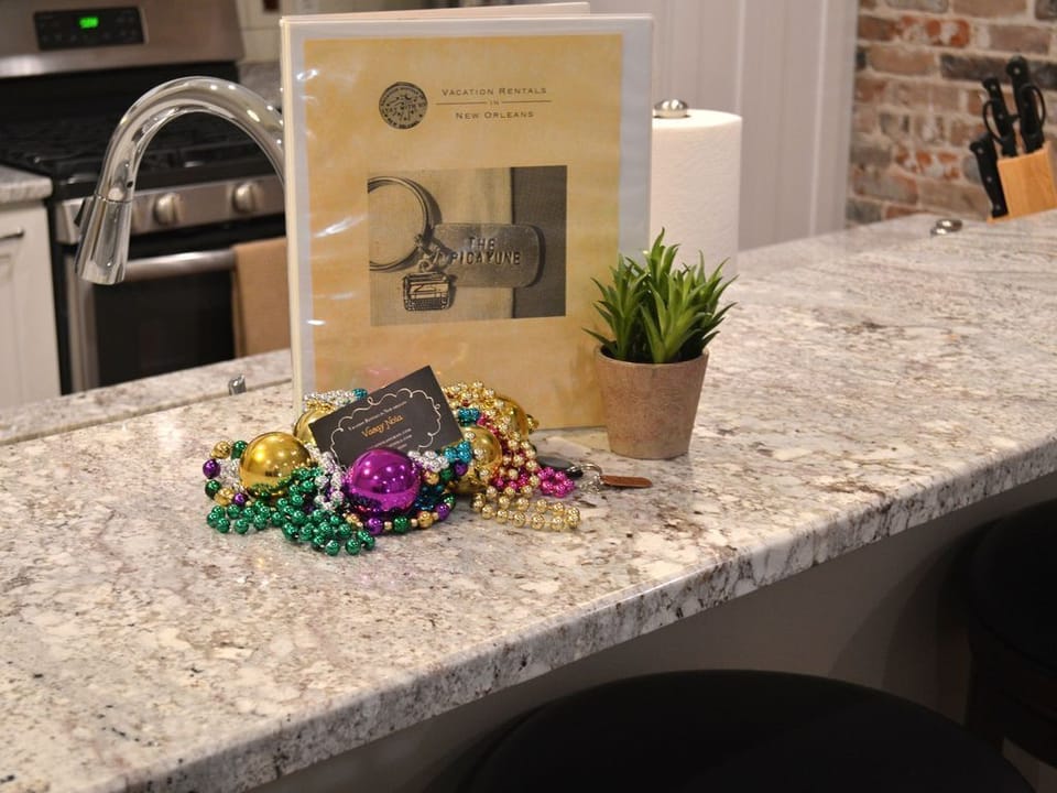 VacayNOLA Guest Book, has condo information. The Mardi Gras beads are yours as souvenirs, take them!