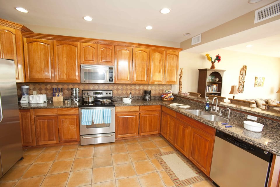Gourmet kitchen with tile, local hardwood, granite  and stainless appliances