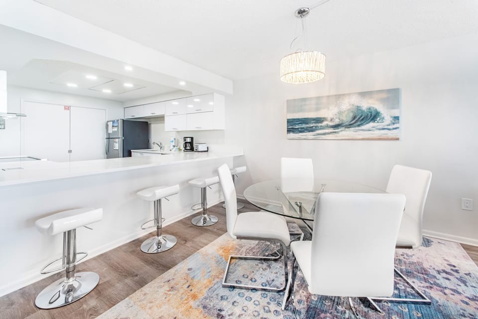 Glass top dining room table with eat-in bar