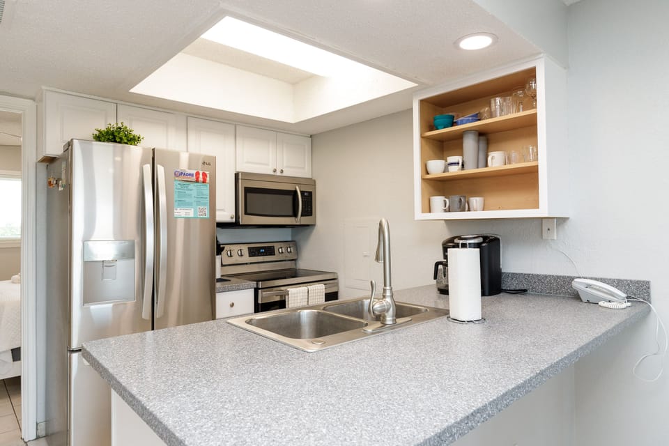 Your fully-equipped kitchen awaits with modern appliances and granite countertops, perfect for preparing home-cooked meals during your stay.