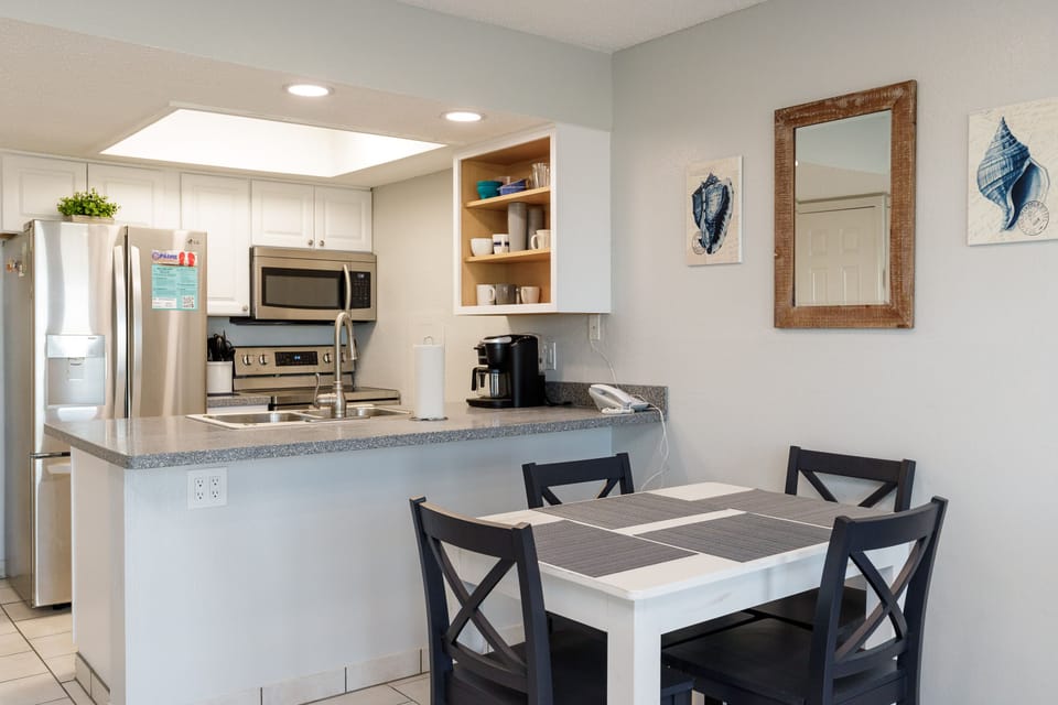 Prepare your favorite meals in this fully-equipped kitchen with granite countertops, stainless appliances, and open breakfast bar seating.