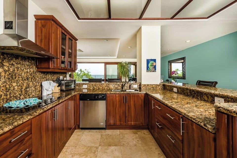 Fully equipped kitchen with generous counter space, full-size appliances, and open layout. Ideal for preparing meals or entertaining. Located in a luxury Tamarindo condo near Langosta Beach with ocean views and private beach access.